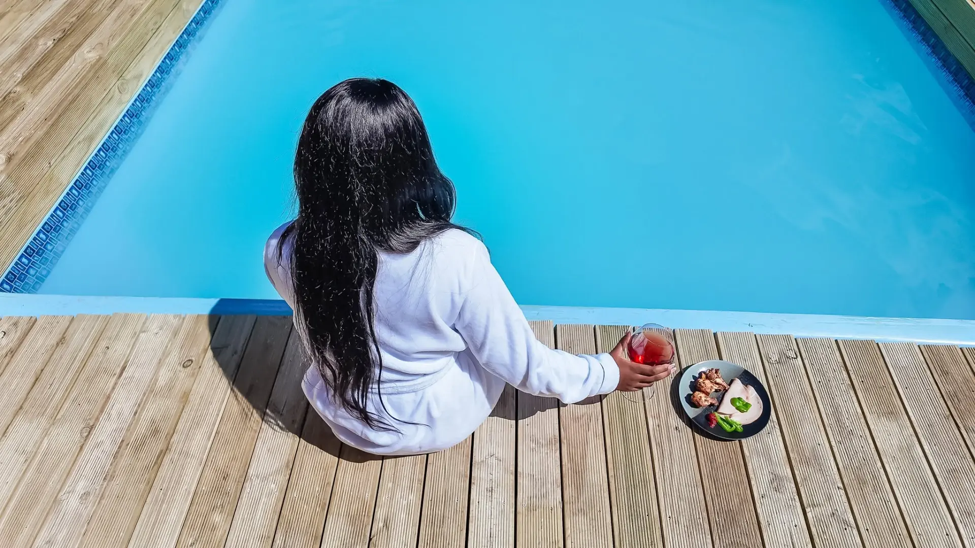 Relaxing by the pool with a drink and snacks
