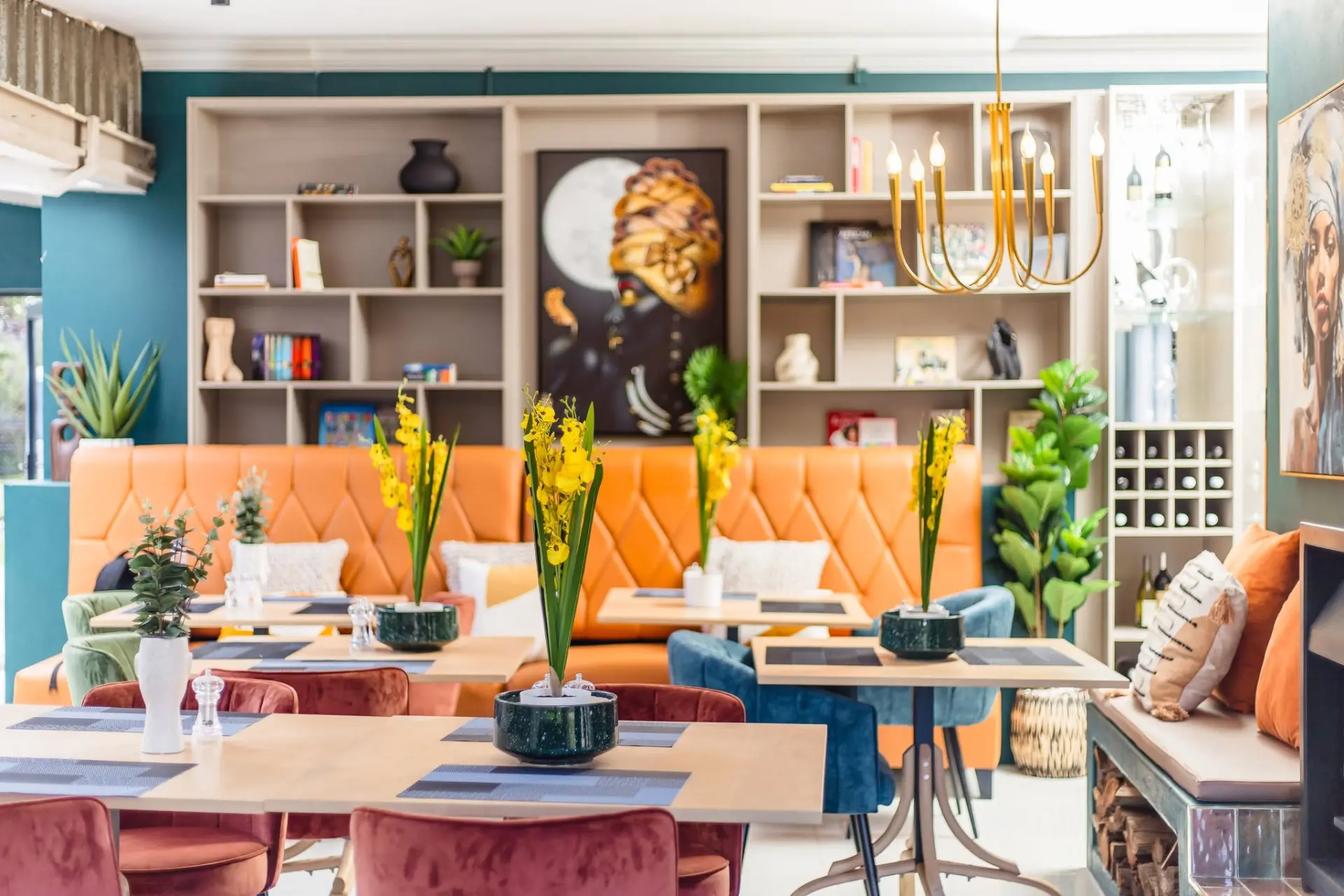 Vibrant dining lounge with orange booth seating