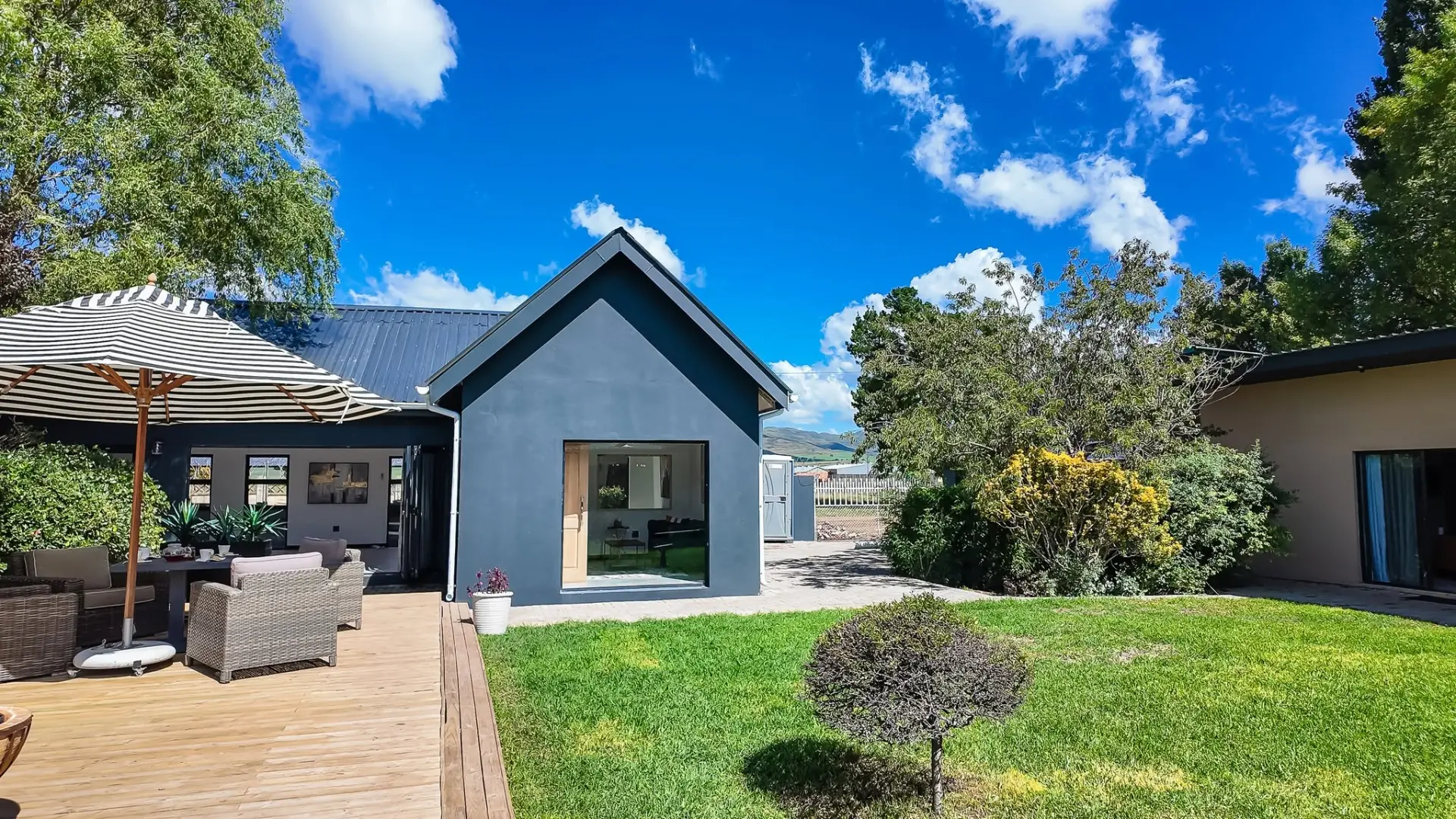 Guest house garden and exterior under a bright blue sky